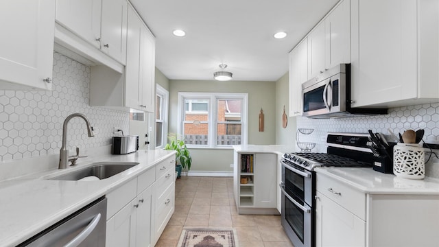 5660 N Rogers Ave, Chicago, IL 60646 - kitchen with appliances with stainless steel finishes, tasteful backsplash, white cabinets, and recessed lighting