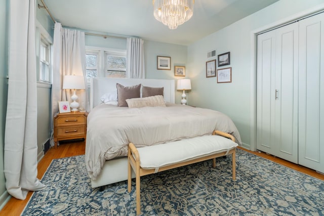 5660 N Rogers Ave, Chicago, IL 60646 - bedroom with wood finished floors, a chandelier, and a closet