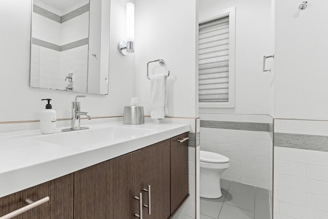 1420 W Fulton St, Chicago, IL 60607 - bathroom featuring vanity, tile patterned flooring, wainscoting, and tile walls