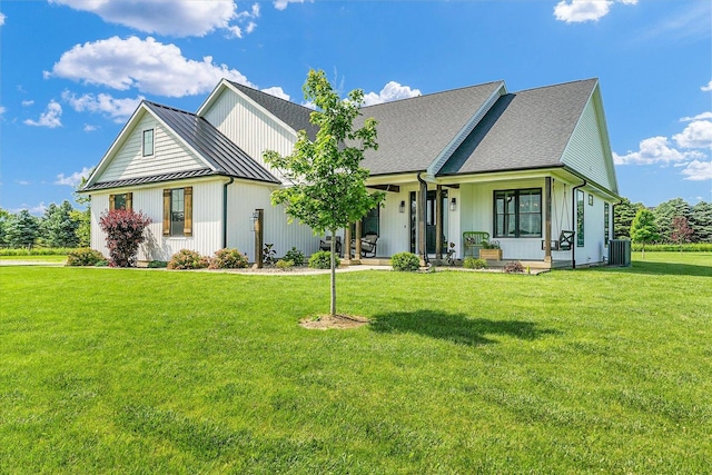 619 County Road 2550 N, Dewey, IL 61840 - modern farmhouse style home with a standing seam roof, covered porch, a front yard, and a metal roof