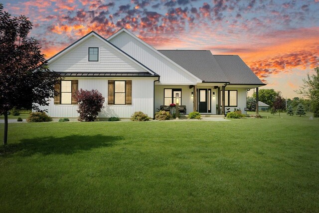 619 County Road 2550 N, Dewey, IL 61840 - back of property at dusk featuring a standing seam roof, a yard, a metal roof, and a porch