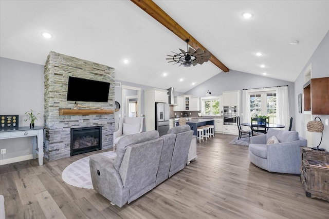 619 County Road 2550 N, Dewey, IL 61840 - living room featuring light wood-style flooring, a stone fireplace, and a ceiling fan