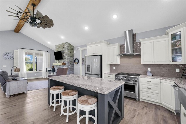 619 County Road 2550 N, Dewey, IL 61840 - kitchen with stainless steel appliances, wall chimney exhaust hood, open floor plan, white cabinets, and glass insert cabinets