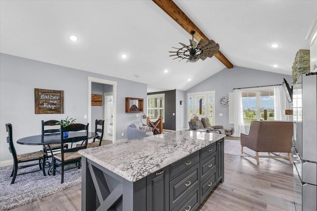 619 County Road 2550 N, Dewey, IL 61840 - kitchen with light wood-type flooring, freestanding refrigerator, a kitchen island, open floor plan, and ceiling fan