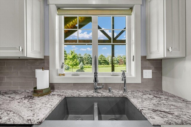 619 County Road 2550 N, Dewey, IL 61840 - kitchen view of tasteful backsplash, white cabinets, and light stone counters