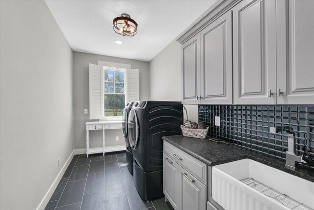 619 County Road 2550 N, Dewey, IL 61840 - laundry room featuring separate washer and dryer, dark tile patterned floors, and cabinet space