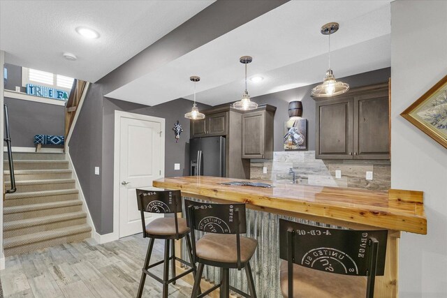 619 County Road 2550 N, Dewey, IL 61840 - kitchen featuring stainless steel refrigerator with ice dispenser, butcher block countertops, dark brown cabinetry, backsplash, and recessed lighting