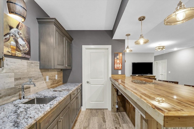 619 County Road 2550 N, Dewey, IL 61840 - kitchen featuring tasteful backsplash, wooden counters, light wood-style floors, pendant lighting, and open floor plan
