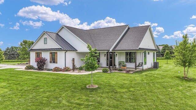 619 County Road 2550 N, Dewey, IL 61840 - modern farmhouse style home featuring a porch, a standing seam roof, a front yard, a metal roof, and roof with shingles