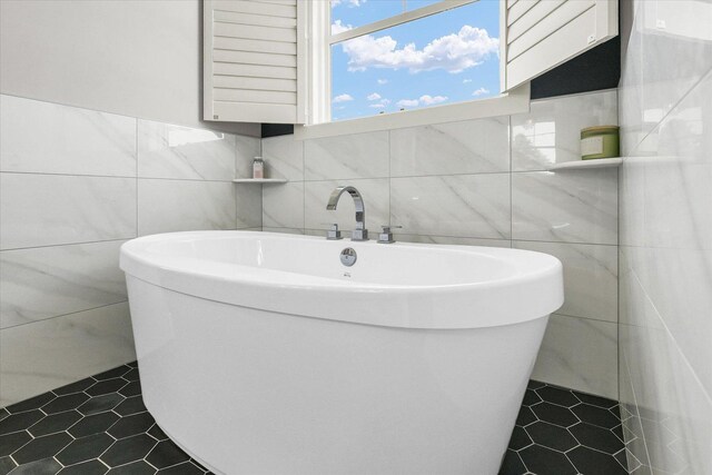 619 County Road 2550 N, Dewey, IL 61840 - bathroom featuring tile walls, a freestanding bath, and tile patterned floors