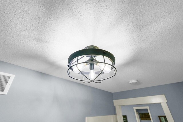 619 County Road 2550 N, Dewey, IL 61840 - detailed view of a textured ceiling, a smoke detector, and a chandelier