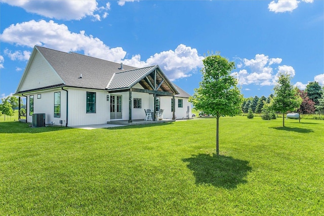 619 County Road 2550 N, Dewey, IL 61840 - back of property with a patio area, a lawn, and a metal roof