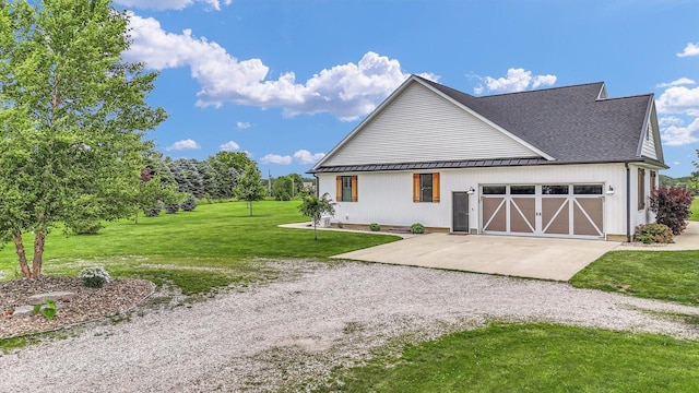 619 County Road 2550 N, Dewey, IL 61840 - view of front facade with driveway, a front yard, an attached garage, a metal roof, and roof with shingles