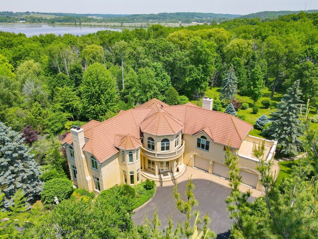 W3318 Lake Forest Ln, Lake Geneva, WI 53147 - view of subject property with a heavily wooded area and a large body of water