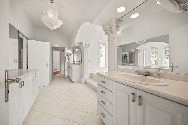 W3318 Lake Forest Ln, Lake Geneva, WI 53147 - bathroom with two vanities, vaulted ceiling, tile patterned flooring, and a chandelier
