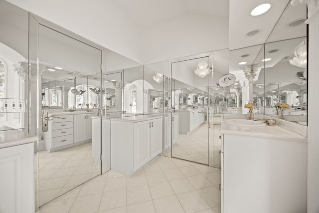 W3318 Lake Forest Ln, Lake Geneva, WI 53147 - bathroom with two vanities, vaulted ceiling, tile patterned floors, and recessed lighting