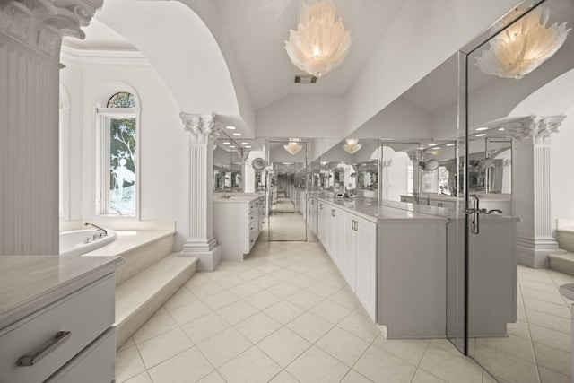 W3318 Lake Forest Ln, Lake Geneva, WI 53147 - full bathroom with ornate columns, two vanities, a bath, tile patterned floors, and lofted ceiling