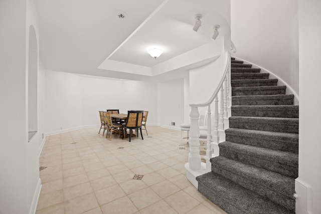 W3318 Lake Forest Ln, Lake Geneva, WI 53147 - dining space featuring stairs, light tile patterned flooring, and a raised ceiling