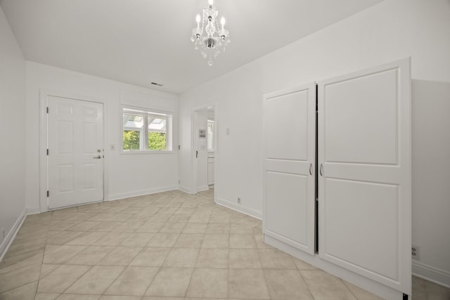 W3318 Lake Forest Ln, Lake Geneva, WI 53147 - entrance foyer featuring a chandelier and baseboards