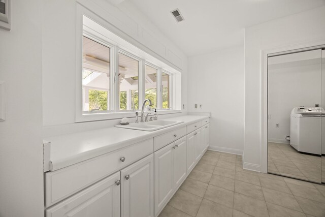 W3318 Lake Forest Ln, Lake Geneva, WI 53147 - kitchen featuring washer / clothes dryer, white cabinets, light tile patterned floors, and light countertops