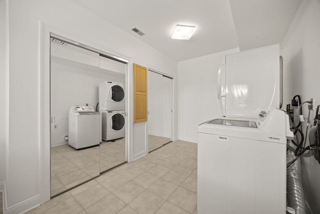 W3318 Lake Forest Ln, Lake Geneva, WI 53147 - laundry room featuring estacked washer and dryer, washer and dryer, and light tile patterned flooring