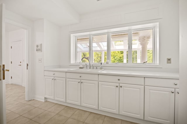 W3318 Lake Forest Ln, Lake Geneva, WI 53147 - kitchen with white cabinets, light tile patterned flooring, and light countertops