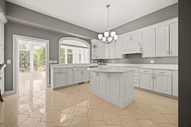 W3318 Lake Forest Ln, Lake Geneva, WI 53147 - kitchen with premium range hood, a chandelier, light countertops, white cabinetry, and a center island