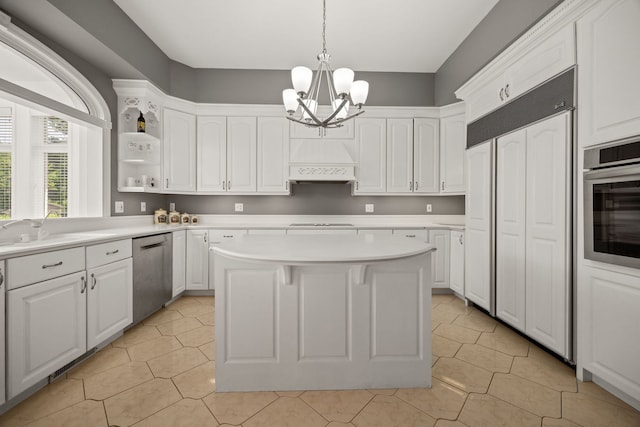 W3318 Lake Forest Ln, Lake Geneva, WI 53147 - kitchen featuring appliances with stainless steel finishes, custom range hood, white cabinetry, a chandelier, and light countertops