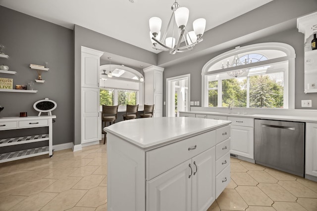 W3318 Lake Forest Ln, Lake Geneva, WI 53147 - kitchen featuring stainless steel dishwasher, a chandelier, a kitchen island, light tile patterned flooring, and white cabinetry