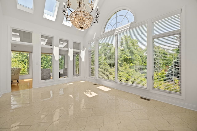 W3318 Lake Forest Ln, Lake Geneva, WI 53147 - unfurnished sunroom featuring a chandelier, a skylight, and a towering ceiling
