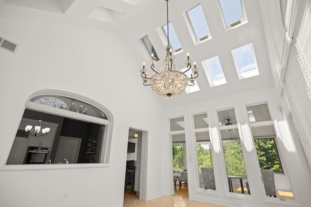 W3318 Lake Forest Ln, Lake Geneva, WI 53147 - interior space featuring a high ceiling, a chandelier, and a skylight