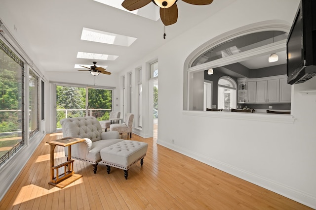 W3318 Lake Forest Ln, Lake Geneva, WI 53147 - sitting room featuring ceiling fan, a skylight, light wood-style floors, and lofted ceiling