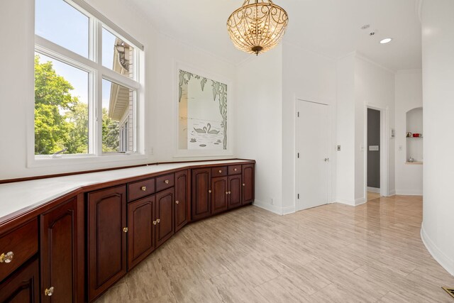 W3318 Lake Forest Ln, Lake Geneva, WI 53147 - hall with healthy amount of natural light, a chandelier, and ornamental molding