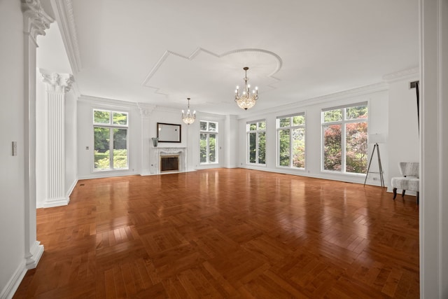 W3318 Lake Forest Ln, Lake Geneva, WI 53147 - unfurnished living room featuring a chandelier, plenty of natural light, a fireplace, and crown molding
