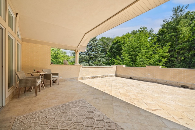 W3318 Lake Forest Ln, Lake Geneva, WI 53147 - fenced backyard with a patio area, outdoor dining space, and view of wooded area