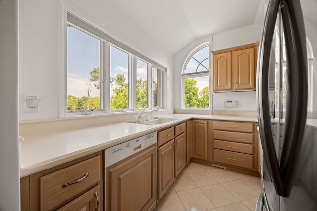W3318 Lake Forest Ln, Lake Geneva, WI 53147 - kitchen with freestanding refrigerator, dishwasher, lofted ceiling, light countertops, and light brown cabinets