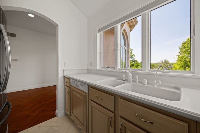 W3318 Lake Forest Ln, Lake Geneva, WI 53147 - kitchen featuring paneled dishwasher, arched walkways, freestanding refrigerator, light countertops, and vaulted ceiling