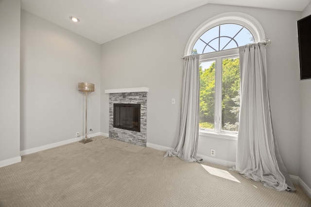 W3318 Lake Forest Ln, Lake Geneva, WI 53147 - unfurnished living room with plenty of natural light, carpet floors, a fireplace, and lofted ceiling