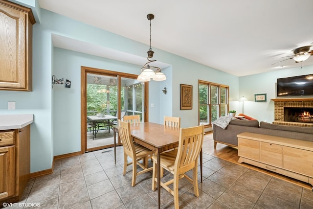 462 Kelly Ln, Crystal Lake, IL 60012 - tiled dining space featuring a brick fireplace and a ceiling fan