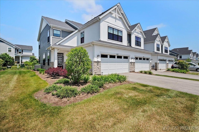 4116 Chelsea Manor Cir, Aurora, IL 60504 - view of front of home with an attached garage, a front lawn, driveway, stone siding, and a residential view