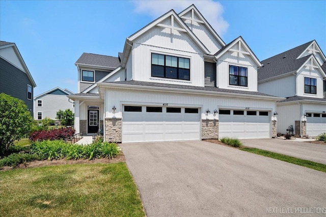 4116 Chelsea Manor Cir, Aurora, IL 60504 - view of front of home featuring stone siding, asphalt driveway, an attached garage, and board and batten siding