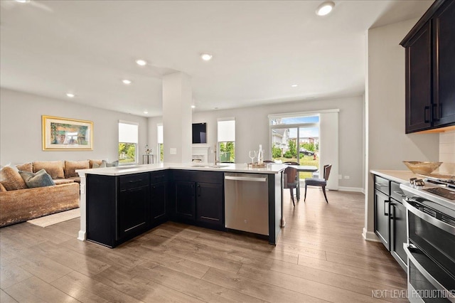 4116 Chelsea Manor Cir, Aurora, IL 60504 - kitchen with appliances with stainless steel finishes, open floor plan, plenty of natural light, light countertops, and recessed lighting