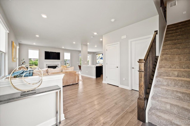 4116 Chelsea Manor Cir, Aurora, IL 60504 - living area with light wood finished floors, a fireplace, stairs, and recessed lighting
