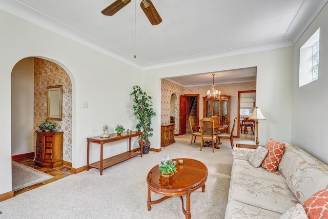 5143 N Monitor Ave, Chicago, IL 60630 - carpeted living area with arched walkways, a chandelier, wallpapered walls, ornamental molding, and a ceiling fan
