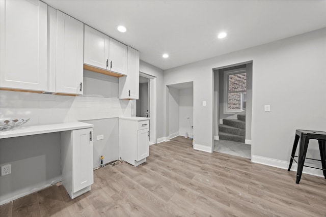 5241 W Adams St, Chicago, IL 60644 - kitchen featuring light wood-type flooring, white cabinetry, light countertops, backsplash, and recessed lighting