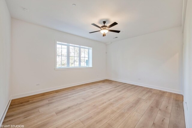 unfurnished room featuring light wood finished floors and ceiling fan