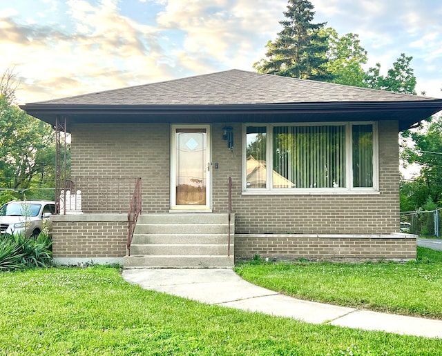 60 W 153rd Pl, South Holland, IL 60473 - bungalow featuring brick siding, a front lawn, and a shingled roof