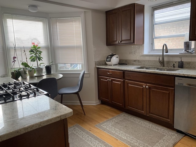 4520 N Austin Ave, Chicago, IL 60630 - kitchen featuring dishwasher, light wood finished floors, light stone counters, and backsplash