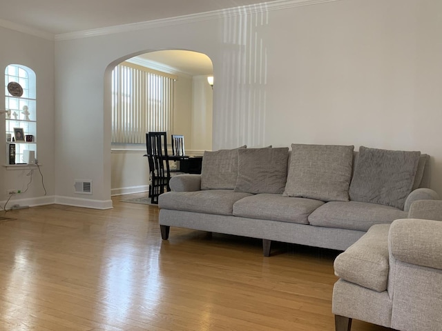 4520 N Austin Ave, Chicago, IL 60630 - living area with arched walkways, light wood-style flooring, and ornamental molding