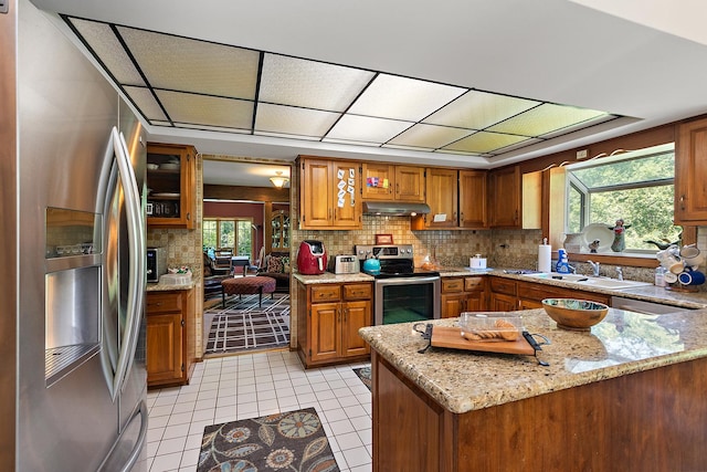 8414 W 119th St, Palos Park, IL 60464 - kitchen with appliances with stainless steel finishes, under cabinet range hood, brown cabinetry, and backsplash